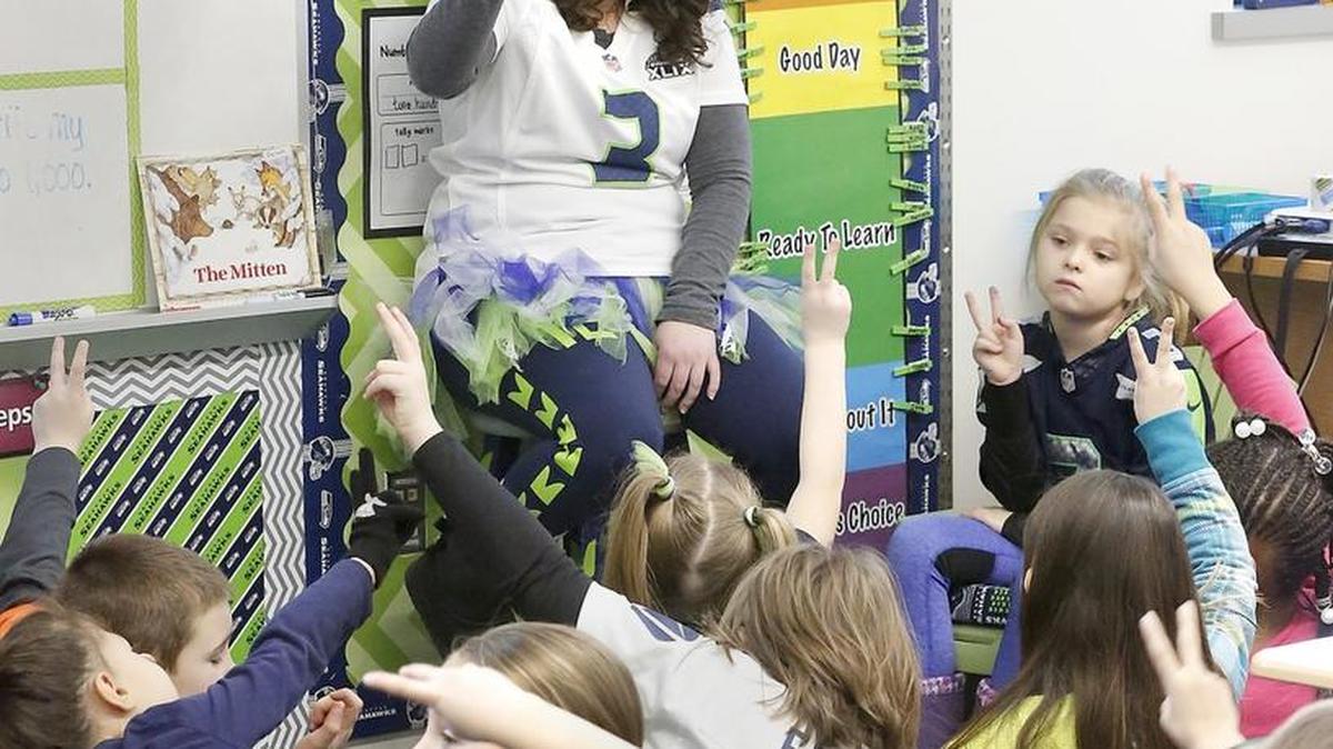 Teacher Krista Barrett is surrounded by Seahawks blue and green on Friday while teaching her second-grade students at Marcus Whitman Elementary School in Richland. Watch a video at tricityherald.com/video