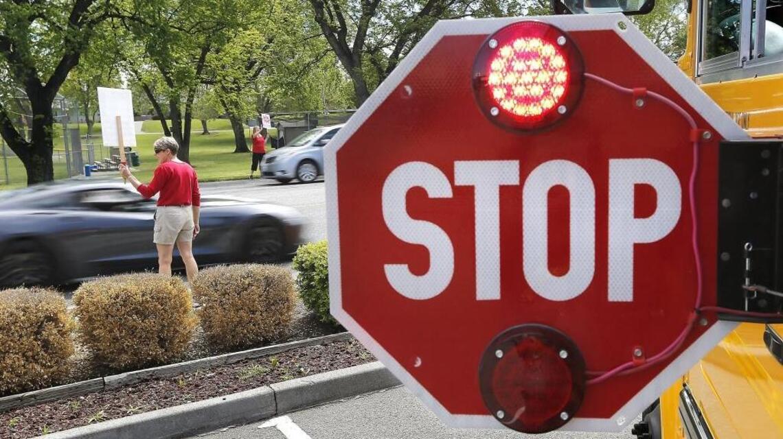 Rules of the Road: A school bus, a four-way stop, and the meaning of ‘either’