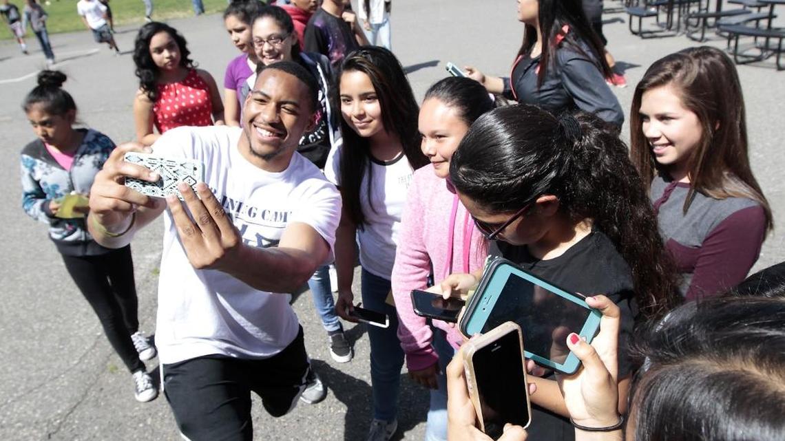 Fever football players celebrate Attendance Matters win with Pasco students