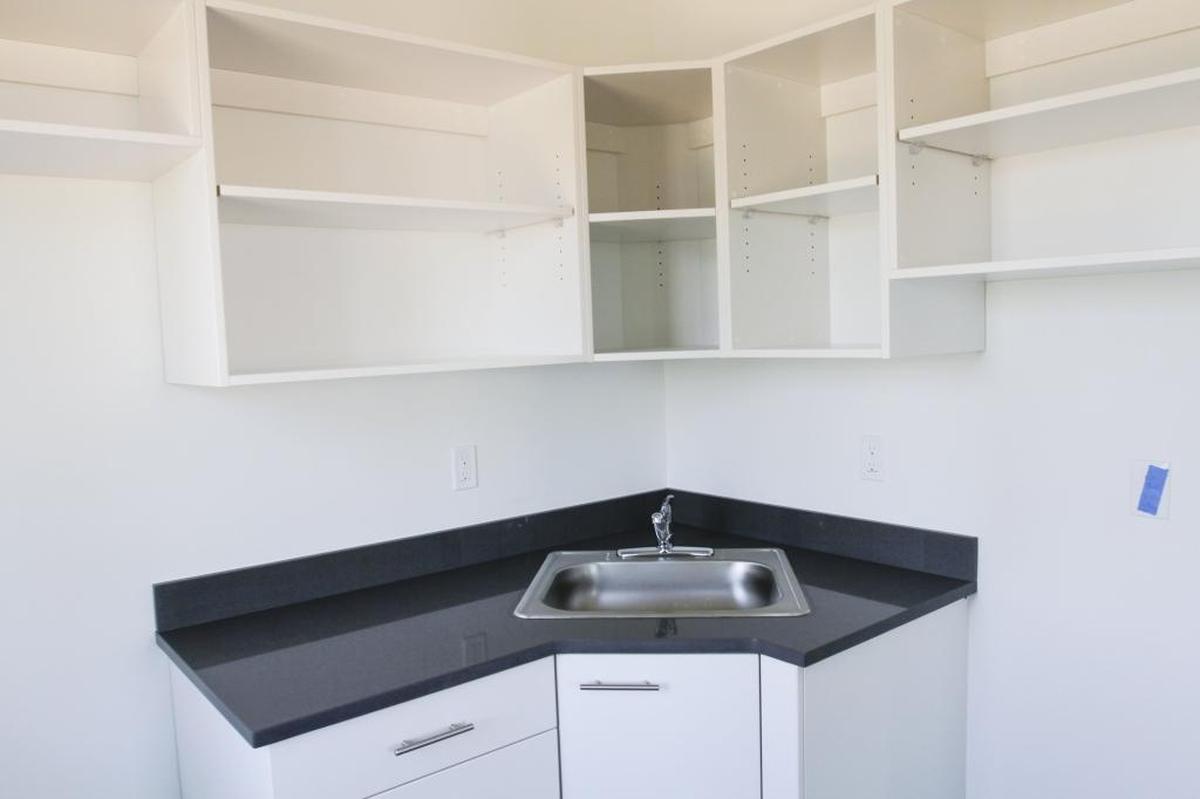 Each apartment in the Columbia Basin College student housing hall in Pasco has a small kitchen with a refrigerator and stove.