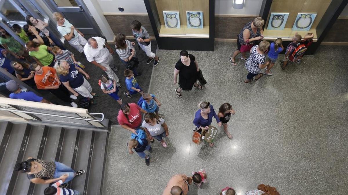 Students and their families walk into the lobby of Sage Crest Elementary School in the Southridge area of Kennewick. The school is the newest elementary school in the Kennewick School District.