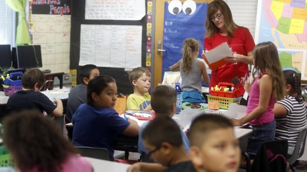 Second grade teacher Alisa Olsen works with students on a project in class at Washington Elementary School in Kennewick. Olsen, who has 29 students this year, says it is the largest class she’s ever had. See a video at tricityherald.com/video.