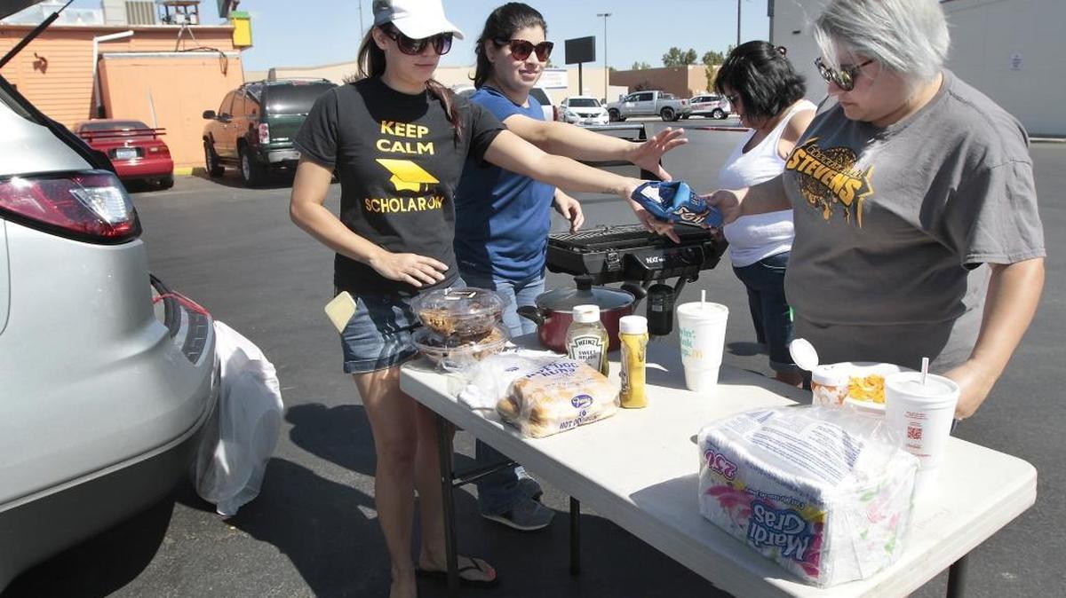 
Stevens Middle school classified staffers clean up Thursday after holding a tailgate-style barbecue lunch of hot dogs, chips and cookies for striking Pasco School District teachers in a parking lot near the intersection of North 22nd Avenue and West Court Street. From left are paraeducators Erin Hall and Maria Campos, secretary Toni Garza and paraeducator Veronica Daniel.
