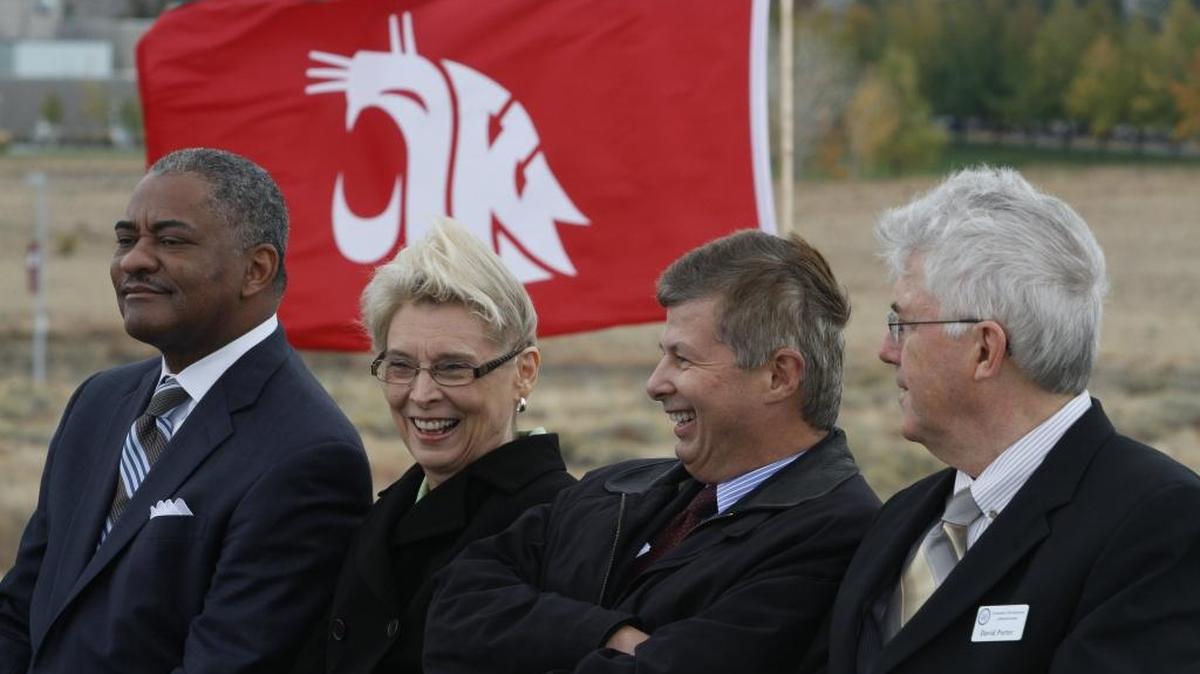 The late Washington State University President Elson Floyd, left, Gov. Chris Gregoire sits on stage alongside, Ted Baseler, chairman of the WSU Wine Campaign, and David Porter of the U.S. Economic Development Administration at the 2012 dedication ceremony for WSU Tri-Cities’ Wine Science Center in Richland.