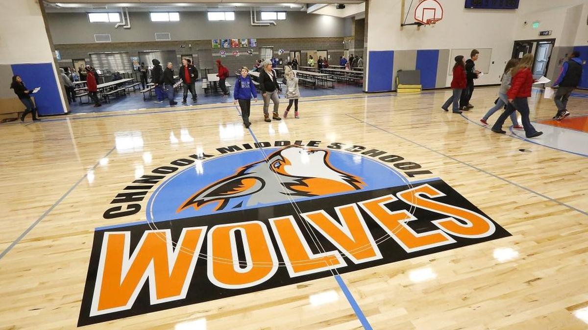 Students, parents and staff at Chinook Middle School walk past the school's mascot on the gymnasium floor Tuesday during an open house. About 790 Kennewick students are to begin attending classes Jan. 4 in the $40 million facility.