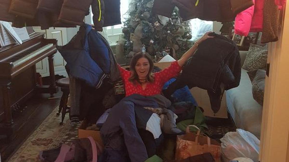Heather Lewis of South Carolina shows the donated coats she received for children at Amistad Elementary in Kennewick.