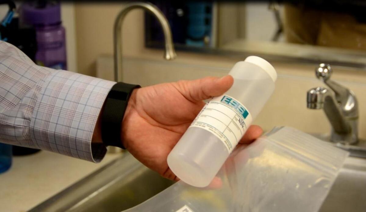 Ryan Mathews, of Fulcrum Environmental Consulting, demonstrates how water is sampled.