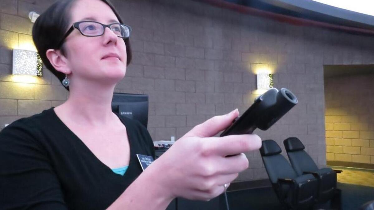 Erin Steinert holds the SCItouch planetarium controller.