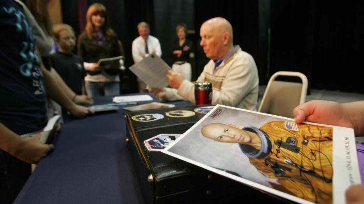 Astronaut Story Musgrave signs autographs during a 2010 visit to Columbia Basin College. He flew on all five space shuttles and was the first astronaut to perform a shuttle spacewalk. He’s returning to the Tri-Cities for three appearances on Sept. 3.