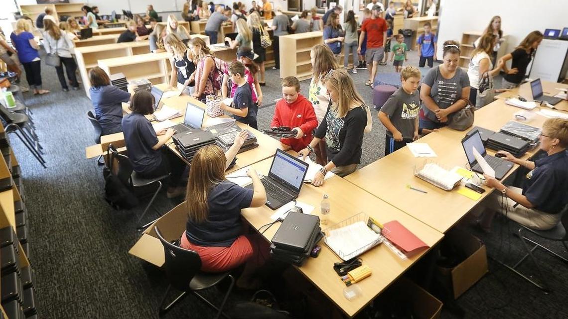 Member of the Richland School District Teaching, Learning & Cirriculum team issue Chromebooks to students at Leona Libby Middle School. The district handed out rougly 680 of the computers, chargers and cases for students to use instead of pencil and paper at the new school's orientation sessions.