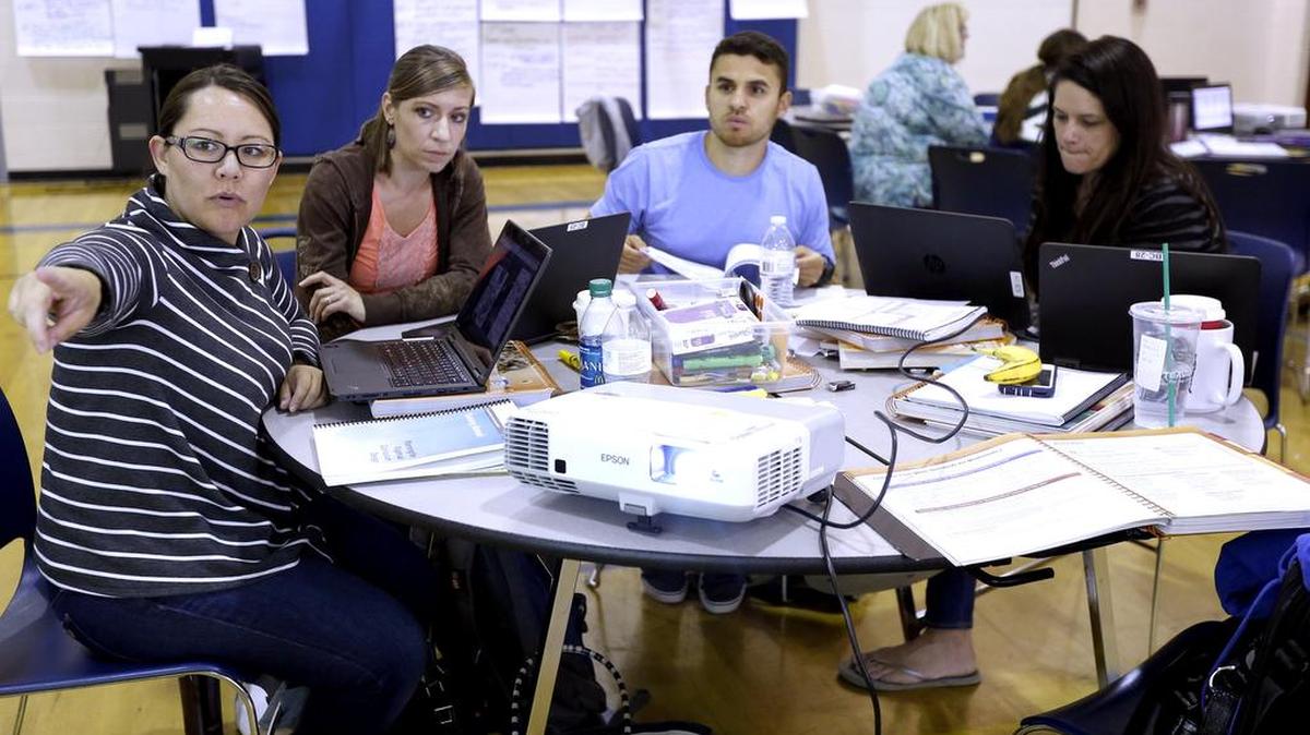 Mikey Kondo, left, a fifth-grade math teacher with the Pasco School District, works with colleagues, from right, Linnea Banta, Daniel Garza and Heather Henry on curriculum changes.