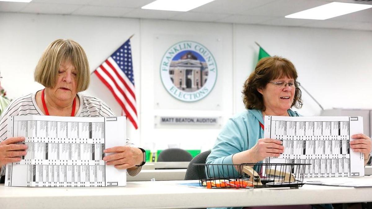 Franklin County election workers Judy Moore, left, and Marjy Leggett prepare early returned ballots for the tabulation machines in November at the Franklin County Elections Center in Pasco.