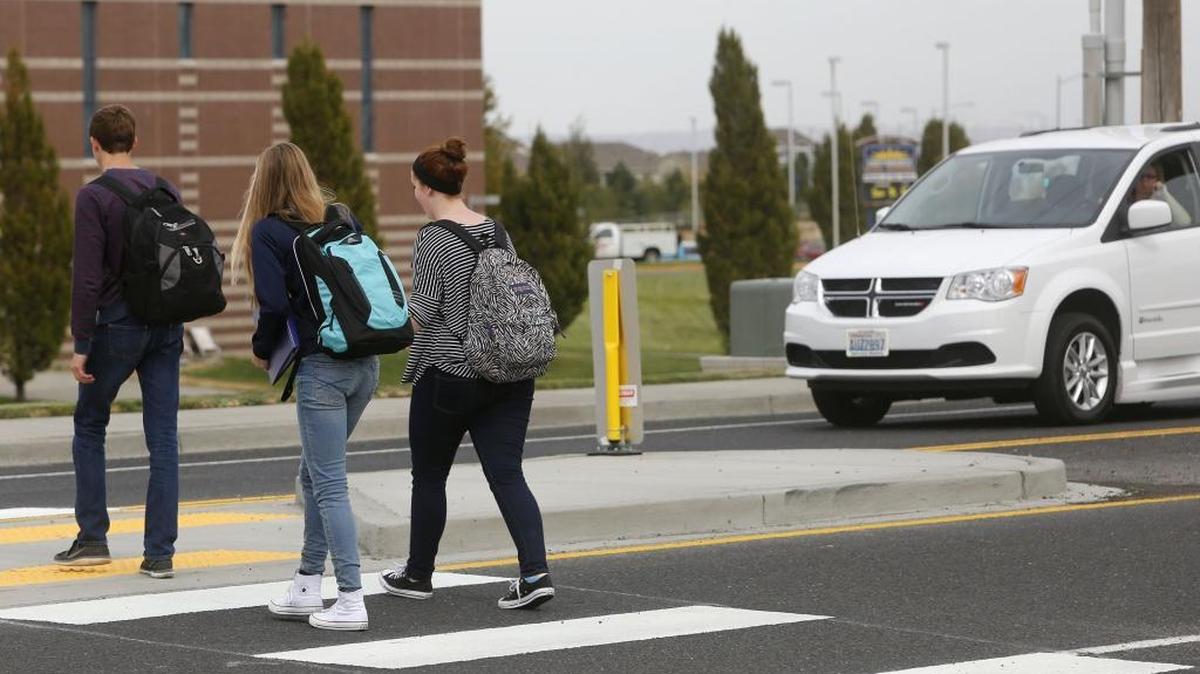 
A car waits for Southridge High School students to cross at the new crosswalk on West 36th Place between the school and a Morman seminary. Approximately $14,000 was raised by the SHS Pedestrian Safety Community to help pay for the crosswalk where four students have been injured in recent years. A ribbon cutting ceremony will be held at 9:45 tomorrow morning.
