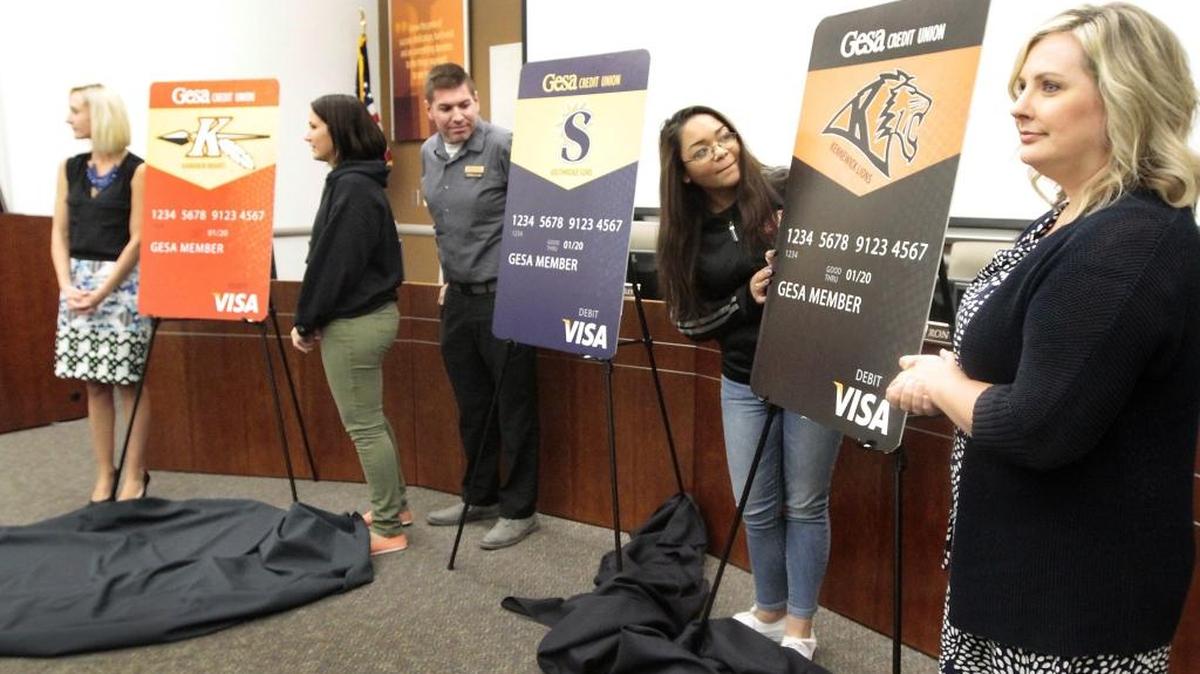 
From left, Kamiakin teacher Olivia Clizbe, junior Calista Gann, Brandon Allison of Gesa Credit Union, Kennewick junior Sayan Banks and Kennewick teacher Kami Smith help unveil new school-branded Visa debit cards at a news conference Wednesday. Watch a video at www.tricityherald.com/video
