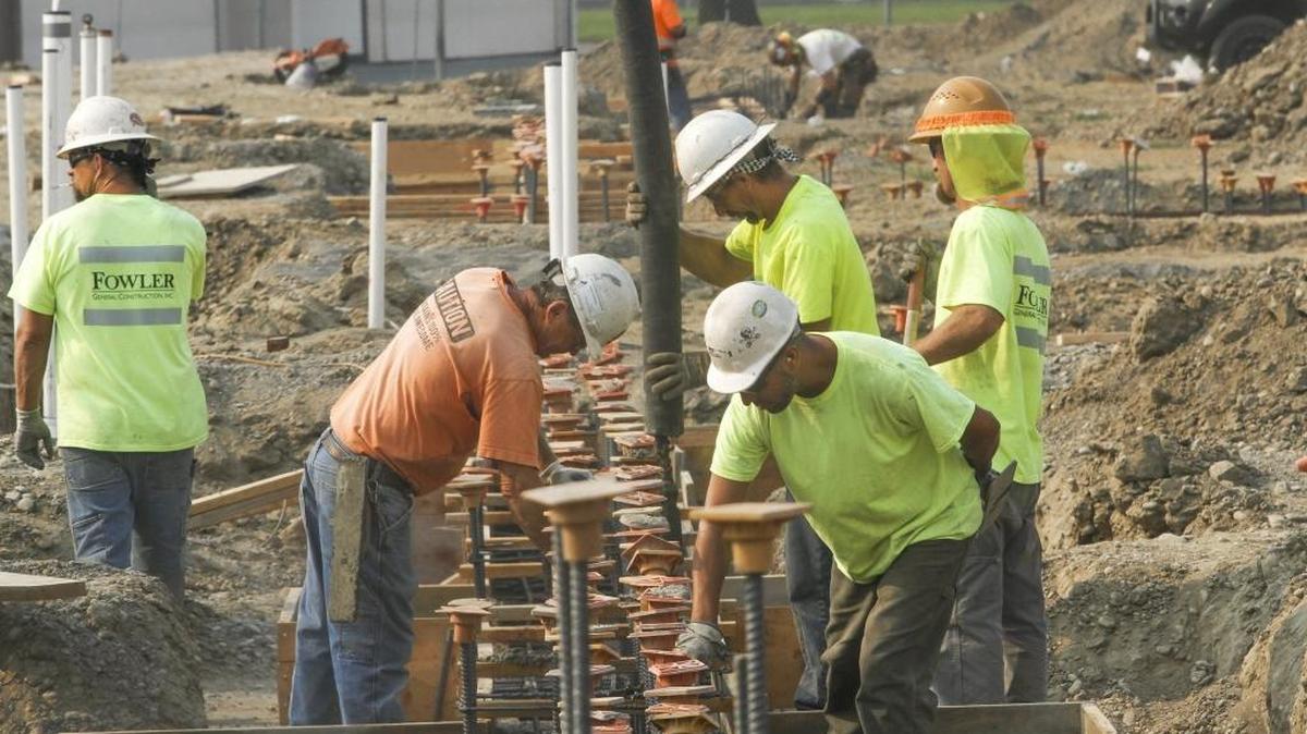 Workers from Fowler General Construction pour concrete on Aug. 3 at the new Jefferson Elementary school building in Richland. The state matching funds are being held up until the state approves a capital budget