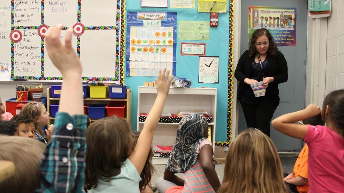 
Evelia Garcilazo, a student teacher in the second-grade classroom of teacher Susanne Diaz at Richland’s Marcus Whitman Elementary School, goes over lessons with students. Garcilazo and other student teachers are already being courted by districts for full-time teaching jobs next fall, as are college graduates who don’t have a teaching degree but are interested in working in classrooms. 
