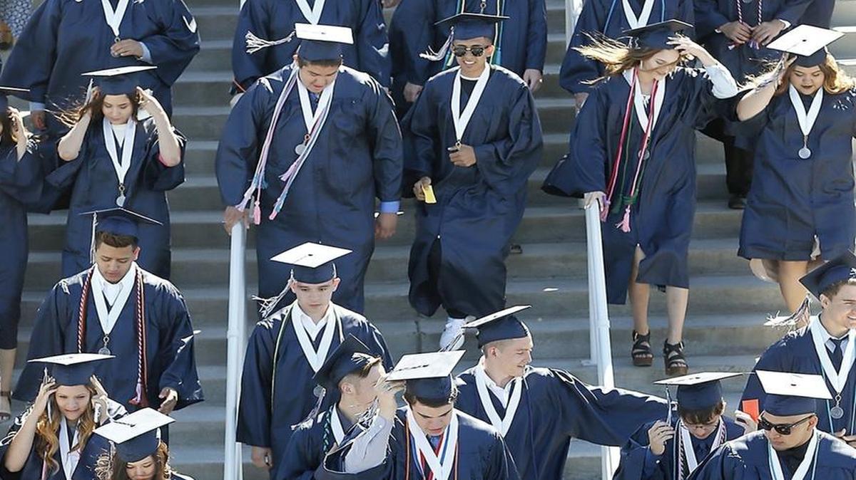 Members of the Chiawana High School Class of 2016 descend the stairs into Edgar Brown Stadium for the start of their graduation ceremony.