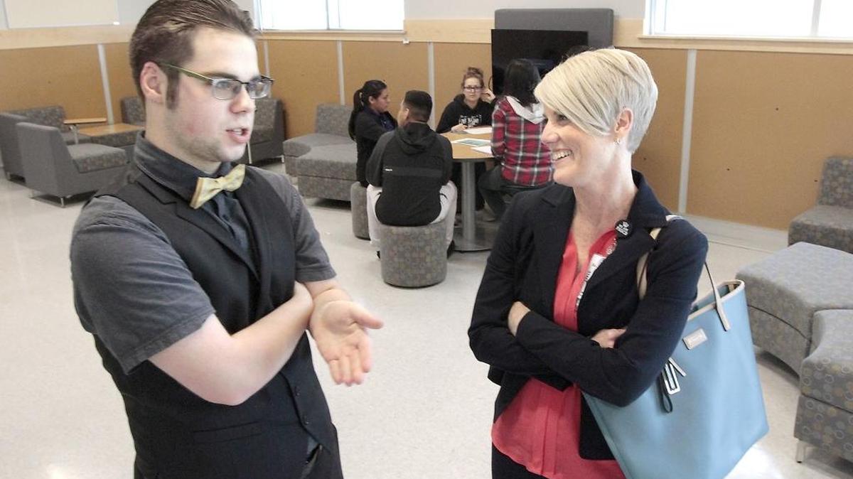 Delta High freshman Mark Freeman talks with Michelle Whitney during a tour Friday of the new campus at 5801 Broadmoor Blvd. in west Pasco.