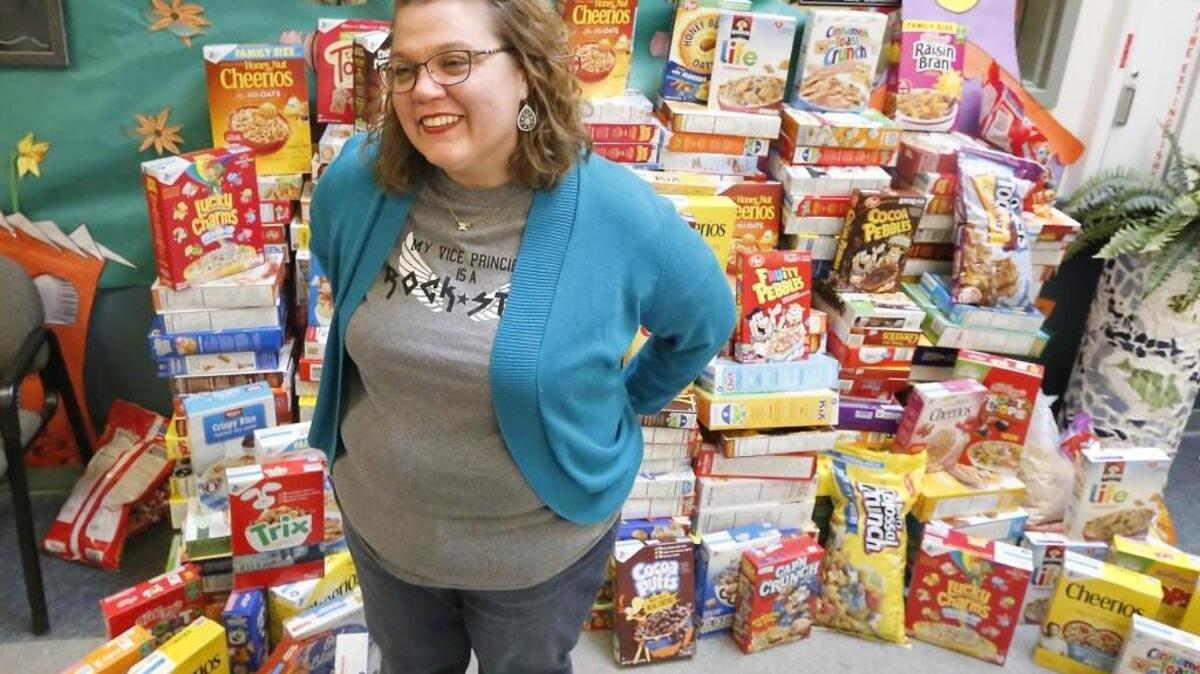 Emerson Elementary Principal Brooke Schuldheisz stands near a stack of about 350 boxes of donated cereal the Pasco school has been collecting for students to take home during spring break. She says the goal is to send home one box with each of their 662 students.