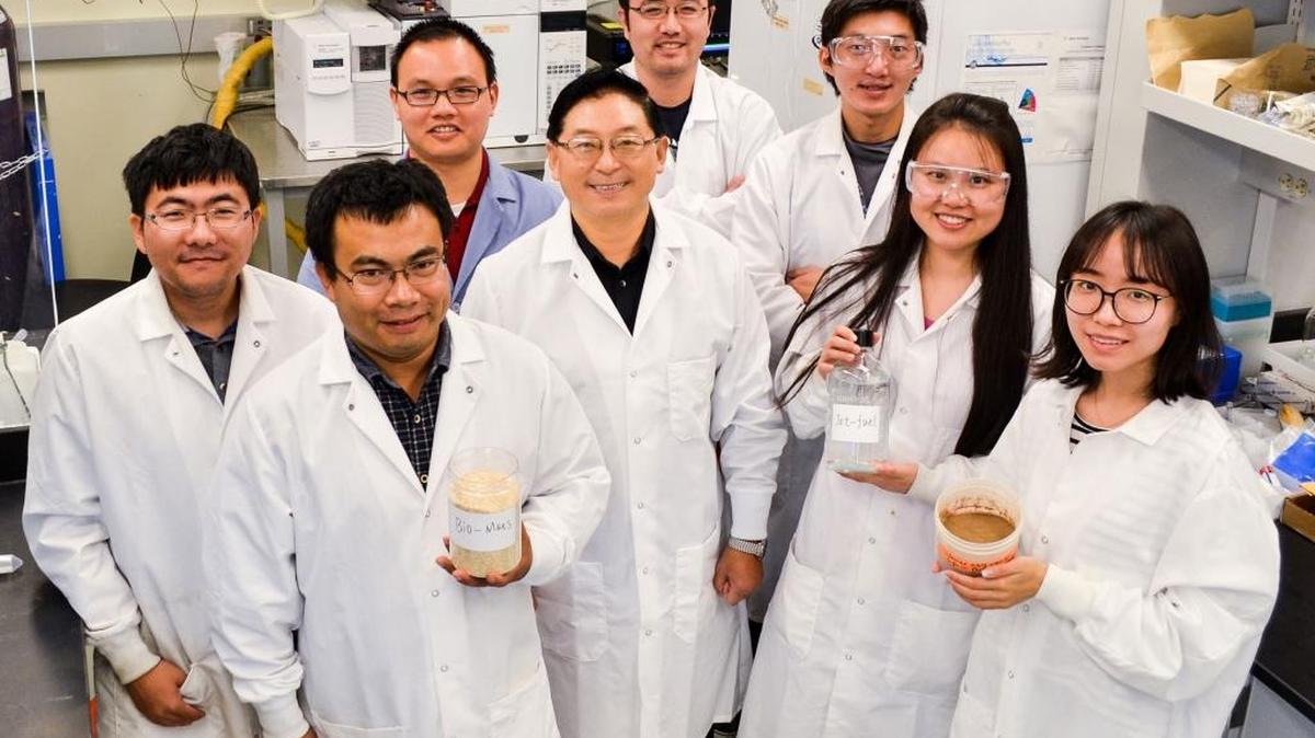 Bin Yang, associate professor of biological systems engineering at WSU Tri-Cities, at center, surrounded by his research team.
