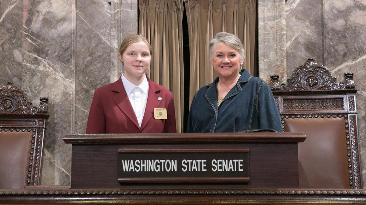 Democratic Sen. Maureen Walsh stands with page Ryanne Eyre in the Washington state Capitol in Olympia.