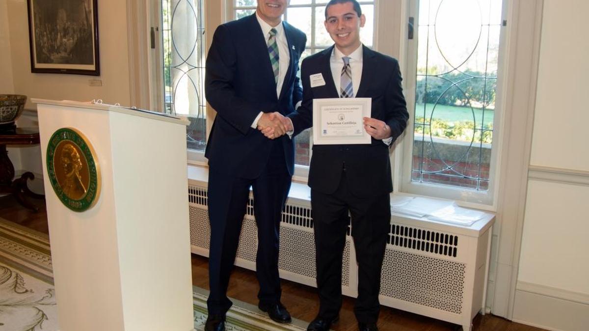 Gov. Jay Inslee shakes hands with Zebbie Castilleja in Olympia. He won the Governor’s Community Service Scholarship.