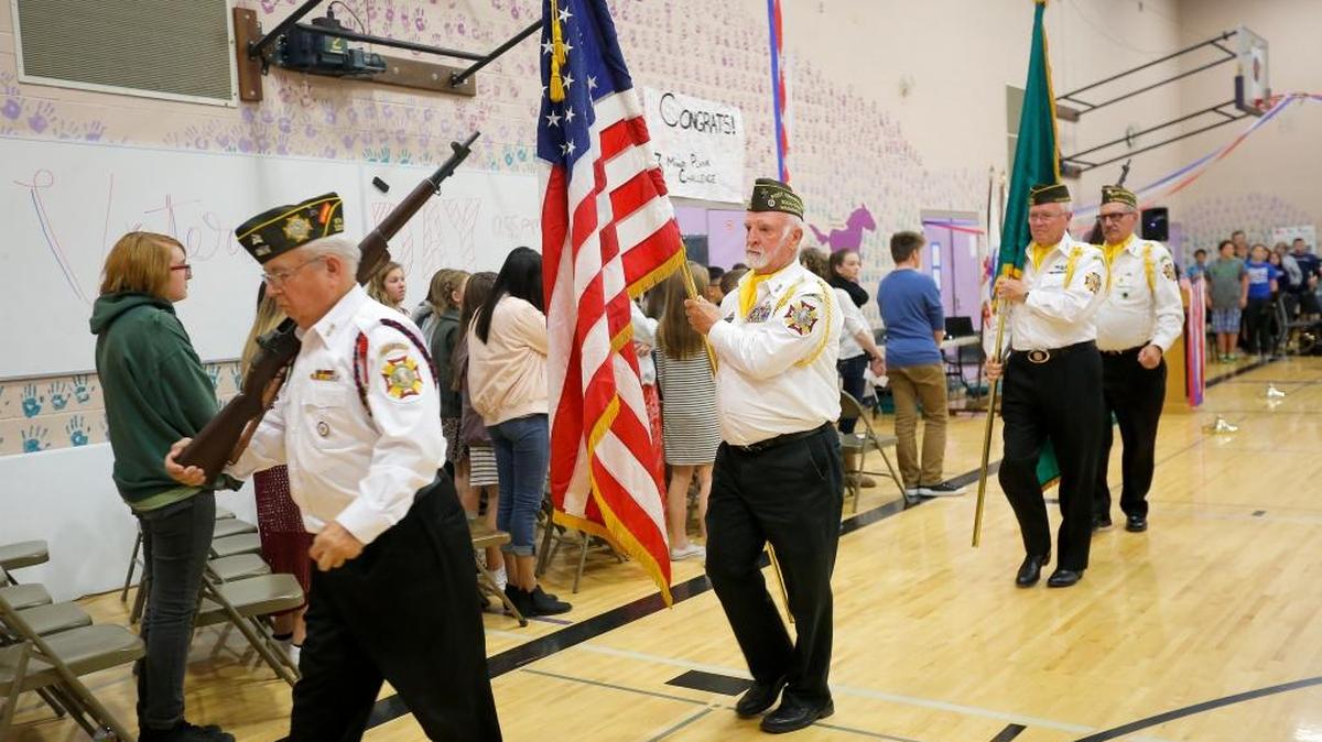 Honor guard members Jerry Peltier, Myrl Briggs, Don Board and Romar Swarner, from West Richland VFW Post 12018, post and retire colors Tuesday during the Veterans Day assembly at Horse Heaven Hills Middle School in Kennewick.