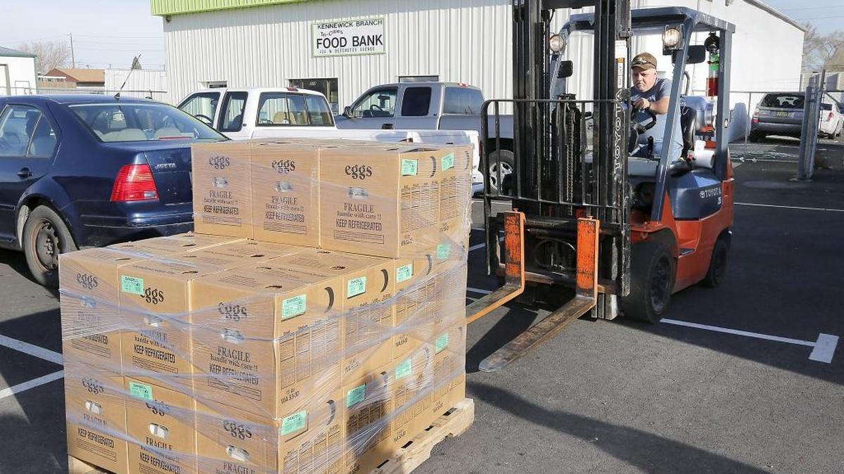 Joe Danley, an employee at Tri-Cities Food Bank, eases a forklift into position Wednesday to move a donation of eggs into a refrigerator at the agency’s central storage facility in Kennewick. Oakdell Eggs in Franklin County and Packaging Corporation of America in Wallula teamed up to donate 900 dozen eggs in time for Easter weekend.