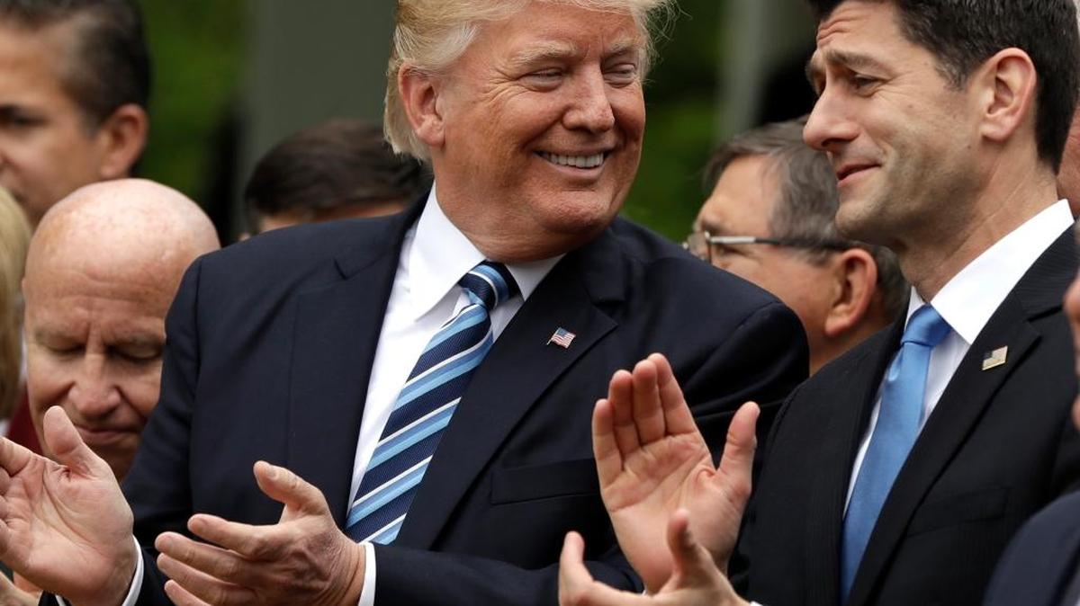 President Donald Trump talks to House Speaker Paul Ryan in the Rose Garden of the White House after the House pushed through a health care bill.