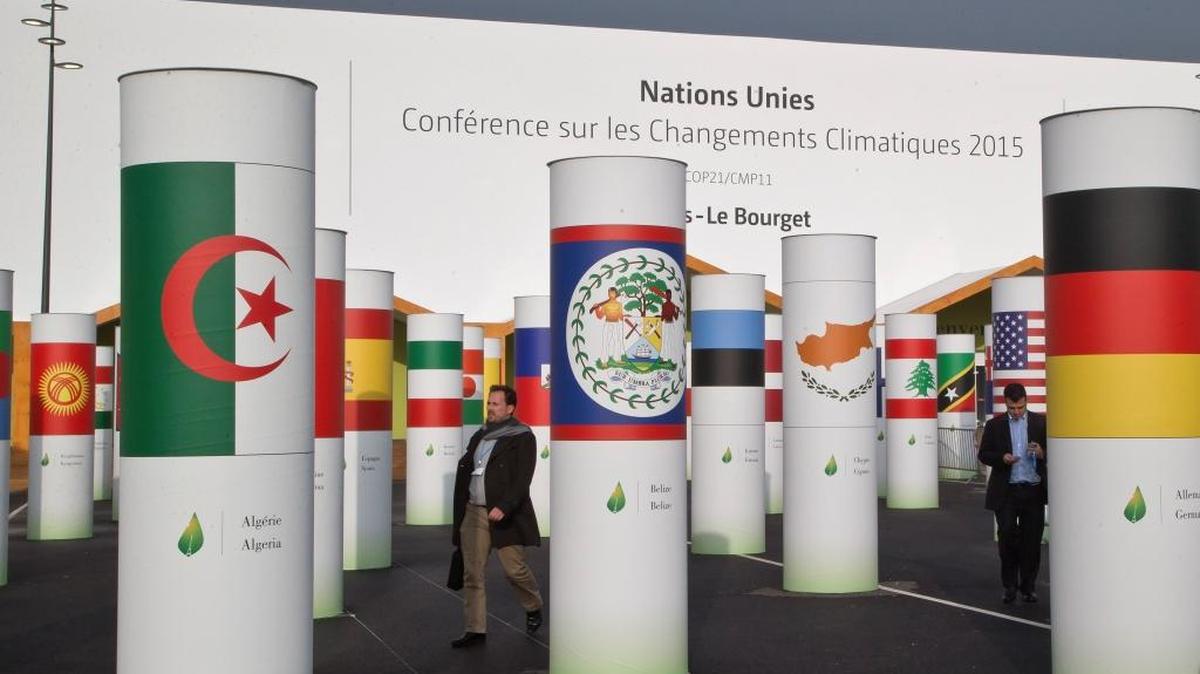 Delegates walk outside the main entrance of the United Nations Climate Change Conference in Le Bourget, outside Paris, on Friday. The conference with more than 100 heads of state is scheduled to start on Nov. 30.