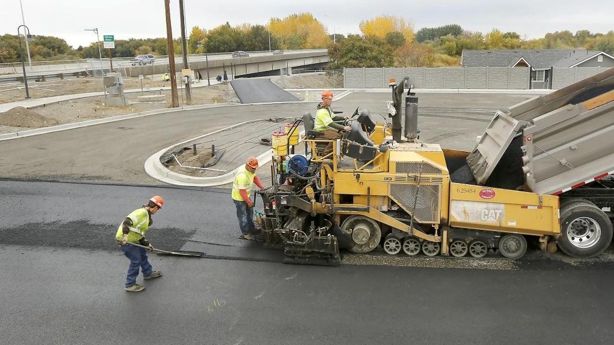 Workers from Inland Asphalt in Richland pave the new 52-space parking lot Thurdsay on the West Richland side of the Van Giesen Street bridge near the Yakima River. The work is part of the Yakima River Gateway project, which is designed to give people better access to the river. A restroom, flood wall, lighted walkway under the bridge, overlook and paved trail are part ot the $2.1 million project. Grants through the Washington Recreation and Conservation Office will cover about $1.7 million of developing the 1,200 feet of shoreline.