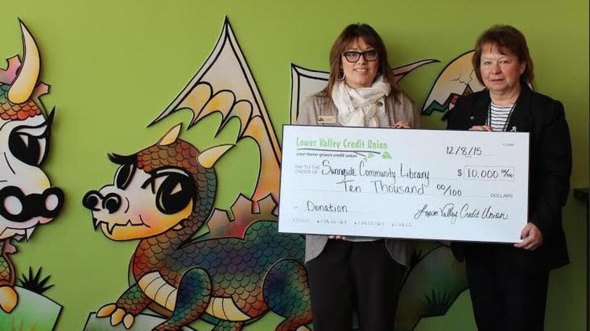 From left to right: Erika Aranda, LVCU Sunnyside branch manager, stands beside Kimberly Hixson, Yakima Valley Libraries director.