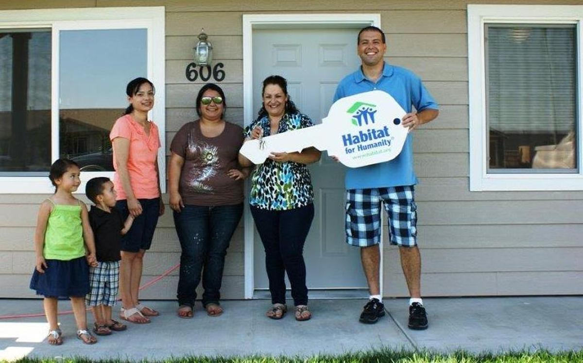 A family at the dedication of their new Pasco home, built through the local Habitat for Humanity, earlier this year.