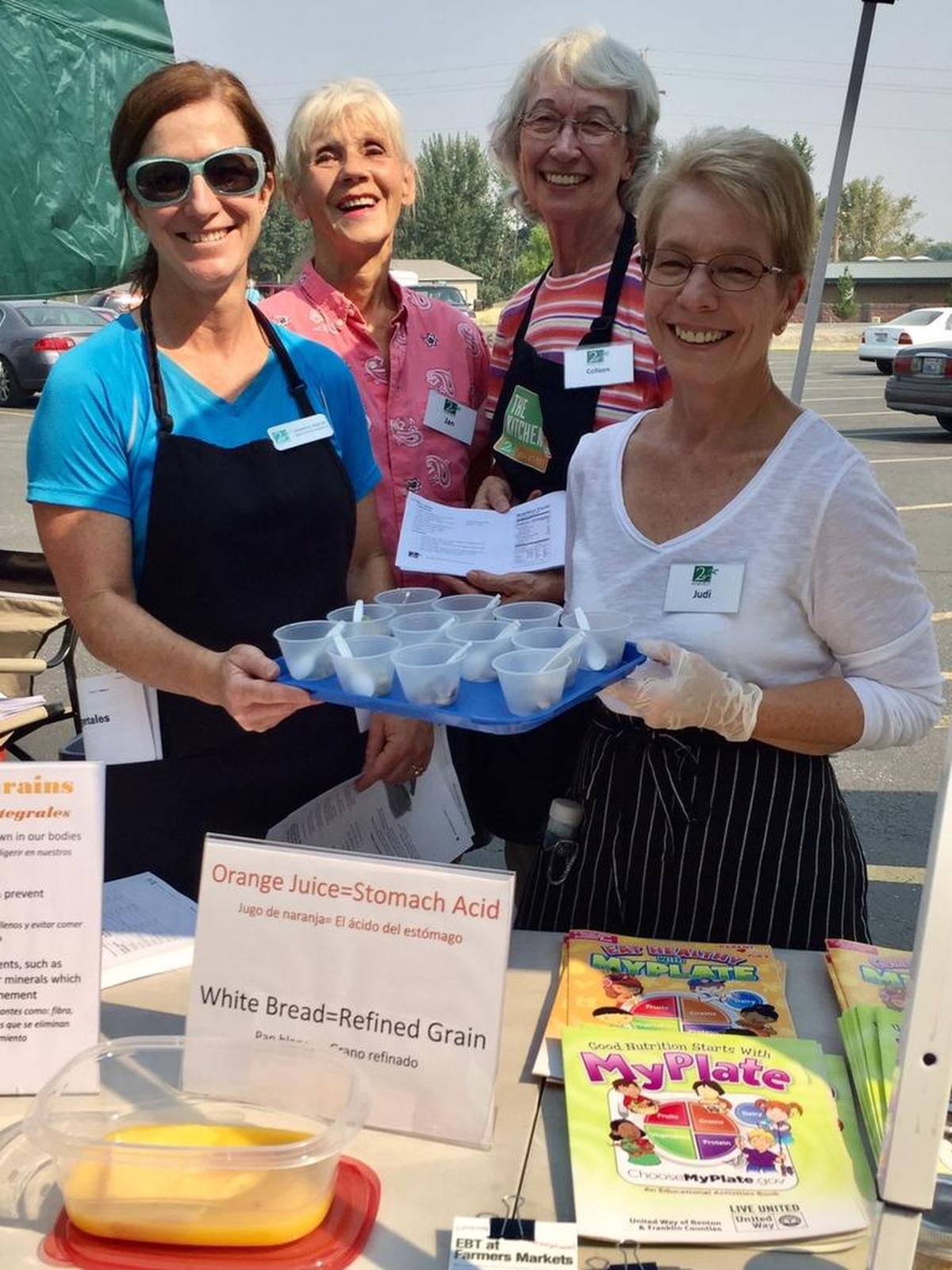 Second Harvest workers hand out samples of a rice salad and provide information on whole grains to clients at a recent Mobile Market. Second Harvest provides food to food banks and food programs, and it also helps people directly through its Mobile Markets and other offerings.