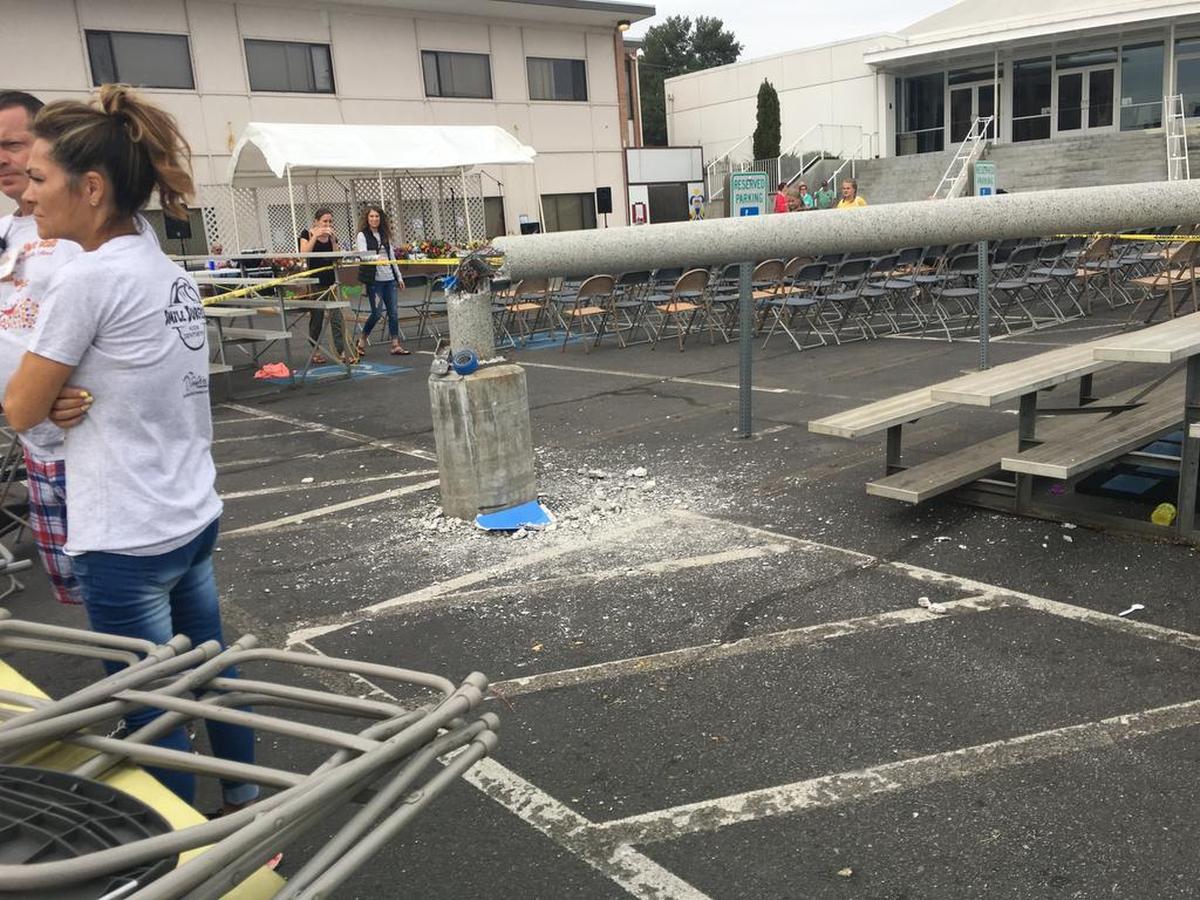 A pole collapsed in the center of Christ the King’s Sausage Fest injuring two people.