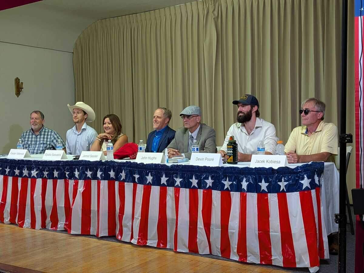 Candidates running for Washington’s 4th Congressoinal District pose for a photo on stage at a forum hosted by Indivisible Yakima at the Fruitvale Grange.