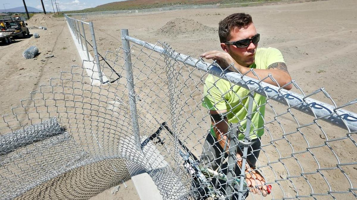 Dakota Musick with Frontier Fence of Pasco tightens chain-link fencing Thursday at the Paws-abilities Place off-leash dog park in south Richland. He is working on the expansion project for the second phase of the five-acre park off Englewood Drive. The project is expected to be finished in July. The former large dog area may reopen in June.