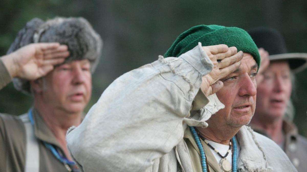 Lewis and Clark Corps of Discovery expedition re-enactors salute the flag.