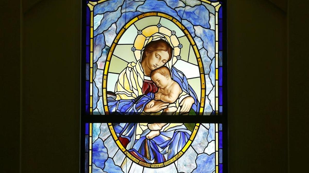 The birth of baby Jesus to the Mother Mary is depicted in stained glass in the entryway of the St. Thomas Aquinas Chapel at Tri-Cities Prep High School in Pasco. The window has special meaning to Nancy and Mike Roach and their family. Artist Patrick Clark used a baby photo of their late son, Luke, for reference when creating the panel.