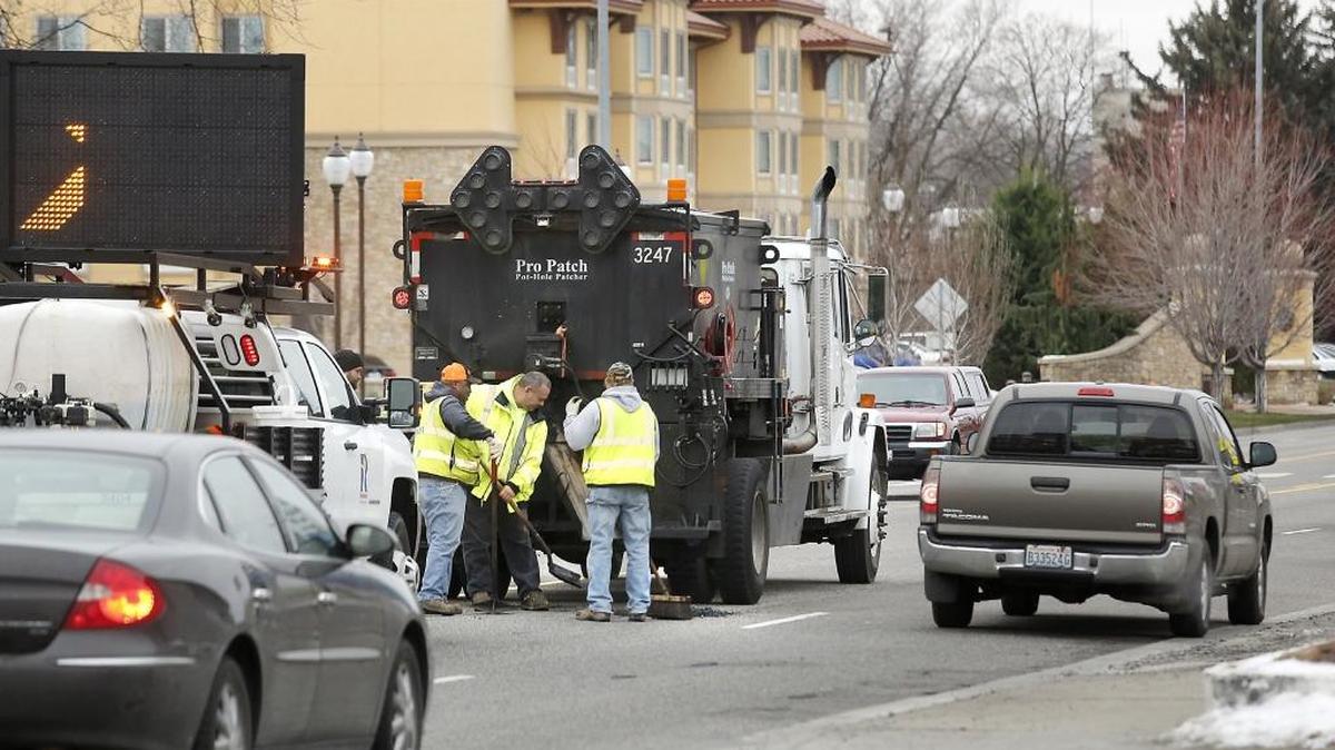 A crew of workers from the City of Richland take advantage of Tuesday morning's dry conditions to make temporary repairs to potholes along George Washington Way.