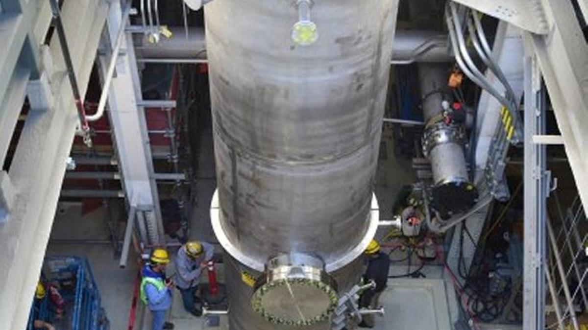 Workers maneuver a 14-ton caustic scrubber into place at the Hanford vitrification plant’s Low Activity Waste Facility after a crane lowered it in through the facility’s roof. Once internal components are installed, it will weigh 19 tons.