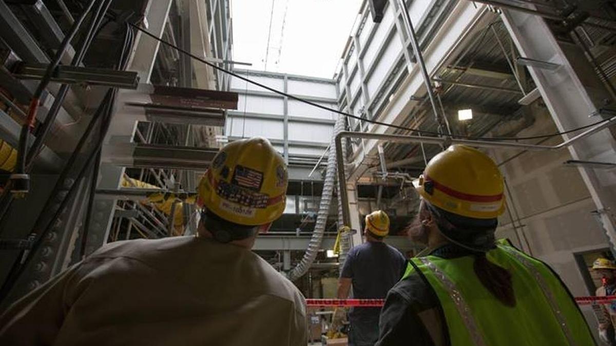 The Low-Activity Waste Facility at the Hanford vitrification plant will treat waste first. Here, employees move pieces of metal platform that major equipment will be set upon. The equipment will be lowered by crane through a hatch above the 48-foot elevation.