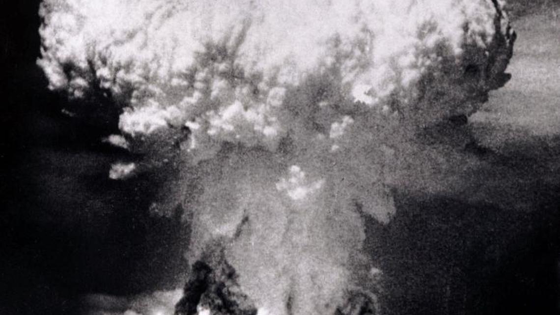 A massive column of billowing smoke, thousands of feet high, mushrooms over Nagasaki, Japan, after the United States dropped an atomic bomb on Aug. 9, 1945. A B-29 plane delivered the blast killing approximately 70,000 people, with thousands dying later of radiation effects.