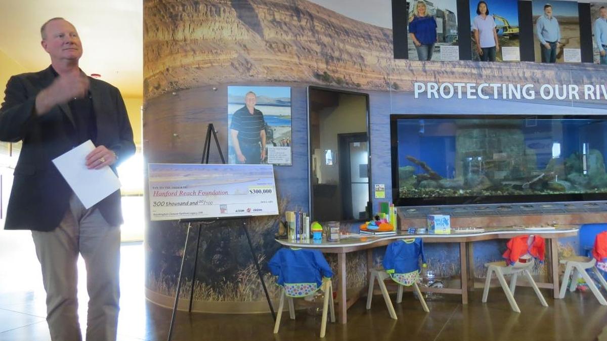 Scott Sax, president of Washington Closure Hanford, announces Monday a $300,000 donation to the Reach center in Richland for projects to help people enjoy the river as newly cleanup land becomes available for public access.