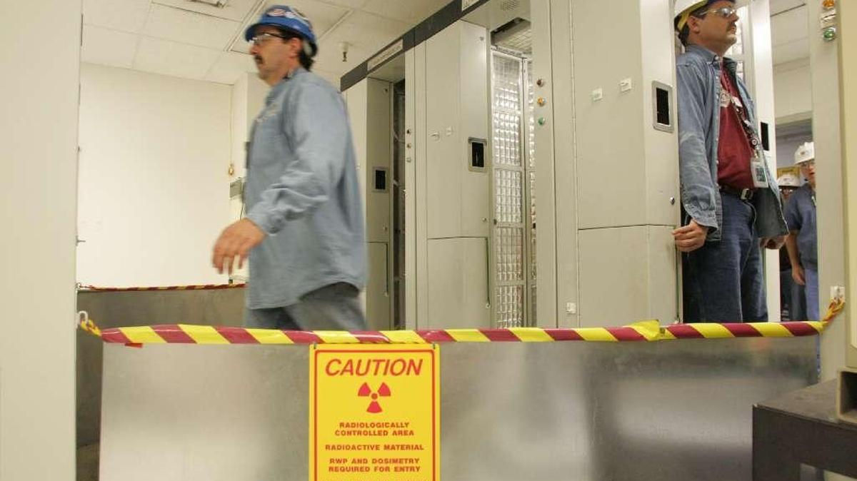 Workers at Energy Northwest's Columbia Generating Station nuclear power plant enter and exit machines that scan them for radiation following their work shifts.