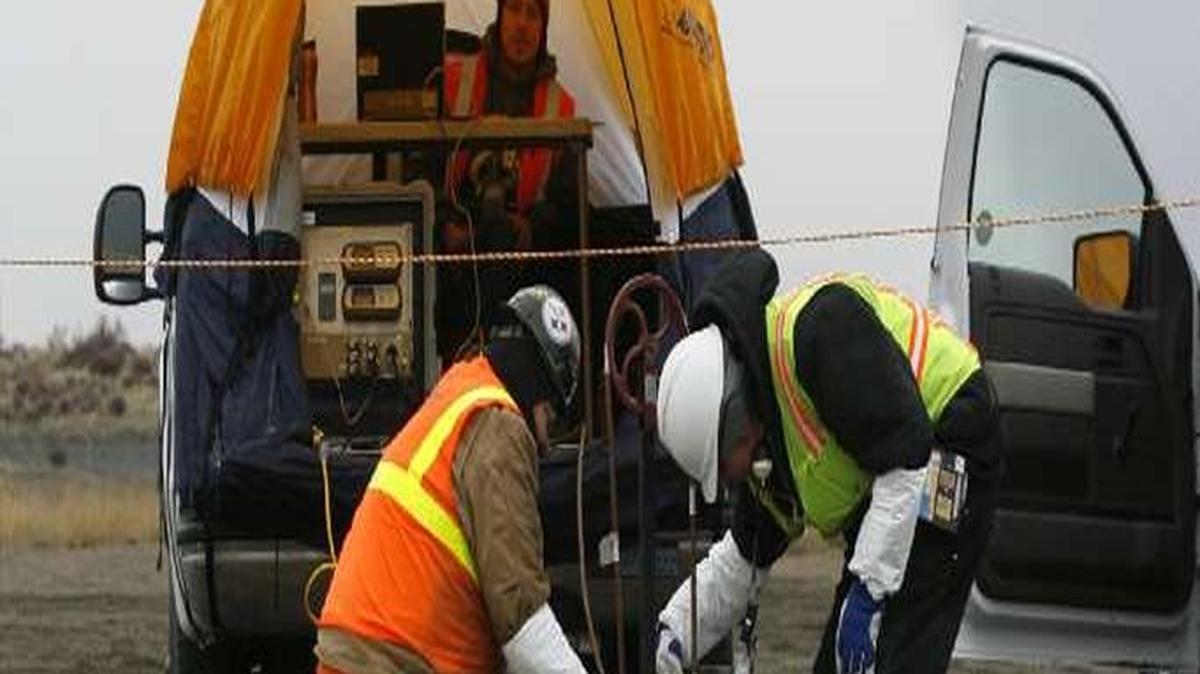 Workers lower a radiation detector underground in 2010 to learn more about what was disposed of in Hanford’s 618-10 Burial Ground. A new report questions how well the detectors worked.