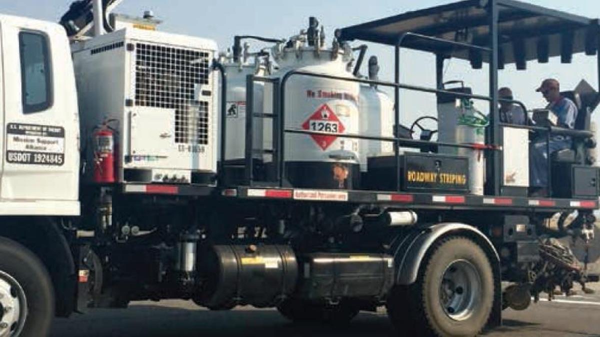 Jeff McDaniel, left, drives a road-striping truck at the Hanford nuclear reservation.