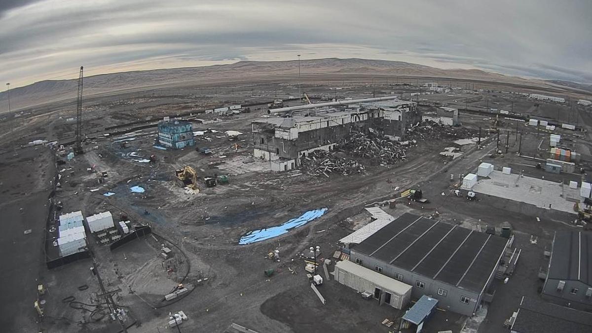 The Plutonium Reclamation Facility, colored blue by fixative to prevent plutonium from becoming airborne, is shown about a month ago with the main processing area of the Plutonium Finishing Plant to its right. The buildings were connected before demolition began.