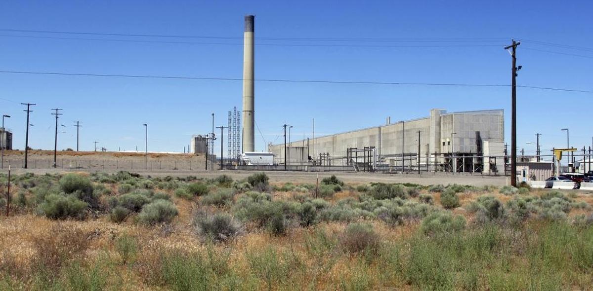 The Plutonium Uranium Extraction Plant, right, is next to a dirt-covered rail tunnel, left, containing radioactive waste, at the Hanford nuclear reservation near Richland.