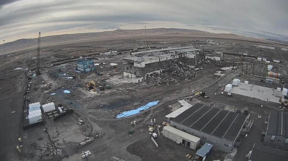 The Plutonium Finishing Plant at Hanford is shown before the demolition of its Plutonium Reclamation Facility, covered in blue fixative, was completed. The facility was once attached to the main plant.